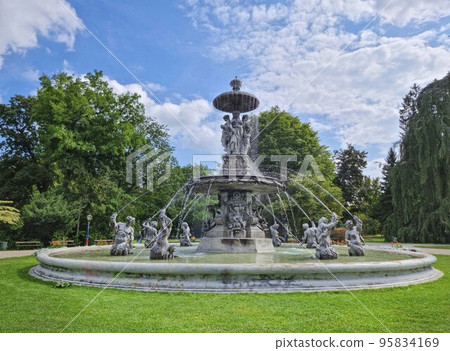 Beautiful fountain in the city park Stadtpark, a green island in the middle of the city center of Graz, Styria region, Austria. Selective focus Beautiful fountain in the city park Stadtpark, a green island in the middle of the city center of Graz, Styria region, Austria. Selective focus 95834169