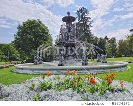 Beautiful fountain in the city park Stadtpark, a green island in the middle of the city center of Graz, Styria region, Austria. Selective focus Beautiful fountain in the city park Stadtpark, a green island in the middle of the city center of Graz, Styria region, Austria. Selective focus 95834171