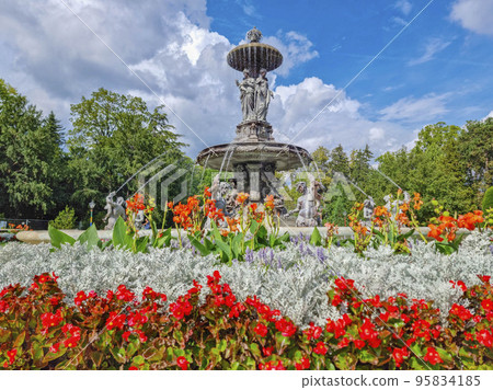 Beautiful fountain in the city park Stadtpark, a green island in the middle of the city center of Graz, Styria region, Austria. Selective focus Beautiful fountain in the city park Stadtpark, a green island in the middle of the city center of Graz, Styria region, Austria. Selective focus 95834185