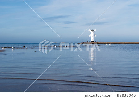 Old windmill lighthouse in Swinoujscie, a port in Poland on the Baltic Sea. 95835049