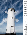 Old windmill lighthouse in Swinoujscie, a port in Poland on the Baltic Sea. 95835061