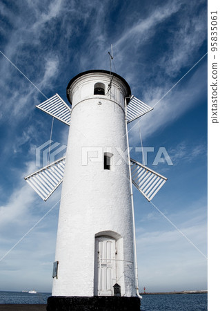Old windmill lighthouse in Swinoujscie, a port in Poland on the Baltic Sea. Old windmill lighthouse in Swinoujscie, a port in Poland on the Baltic Sea. 95835061