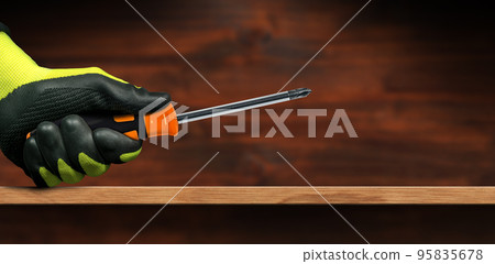 Manual Worker with Protective Work Gloves Holding a Phillips Head Screwdriver Manual Worker with Protective Work Gloves Holding a Phillips Head Screwdriver 95835678