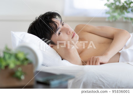 young man waking up in bed young man waking up in bed 95836001