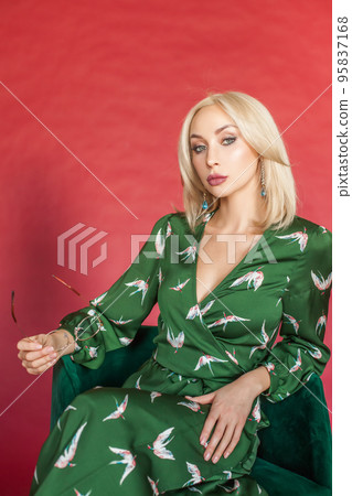 Studio photo shoot of pretty confident blonde woman in fashionable dress Studio photo shoot of pretty confident blonde woman in fashionable dress 95837168