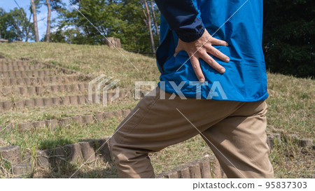 Image of a man with shortness of breath and back pain on the stairs Image of a man with shortness of breath and back pain on the stairs 95837303