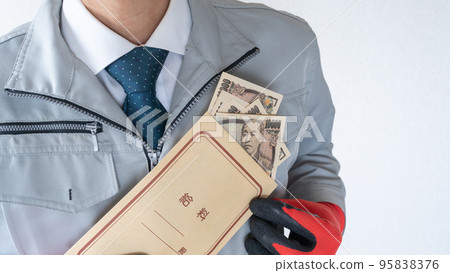 A man in work clothes with a salary bag 95838376