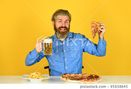 Pizzeria restaurant. Cheerful man bearded hipster eat pizza. Could not be better. Pizza party concept. Beer and food. Dinner at pub. Hungry man going to eat pizza and drink beer. Finally pizza time 95838645