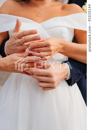 close up. the groom hugs the bride and they exchange rings. close up. the groom hugs the bride and they exchange rings. 95839144