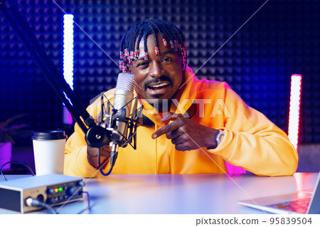Happy young african man audio blogger broadcasting at studio Happy young african man audio blogger broadcasting at studio 95839504