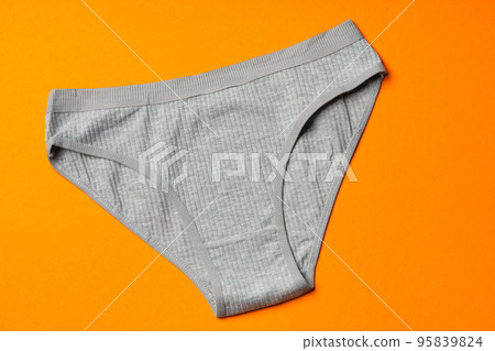 Women's panties on an orange background flat lay 95839824