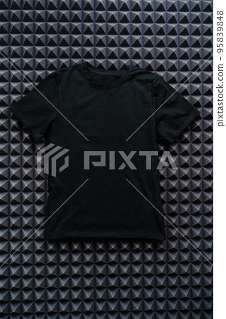 Black color plain t-shirt on textured background 95839848