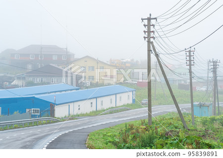 view of the village of Yuzhno-Kurilsk on the island of Kunashir during fog 95839891