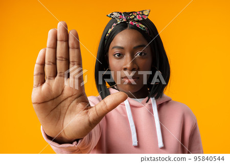 Young african woman over yellow background doing stop sign with palm of the hand 95840544