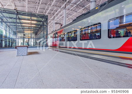Passenger train stands by the platform. 95840906