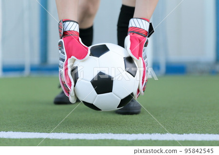 Goalkeeper man setting a soccer ball Goalkeeper man setting a soccer ball 95842545