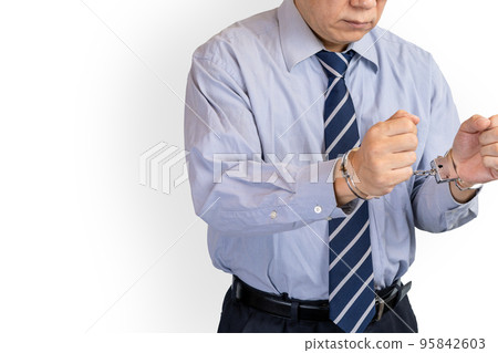 handcuffed businessman handcuffed businessman 95842603