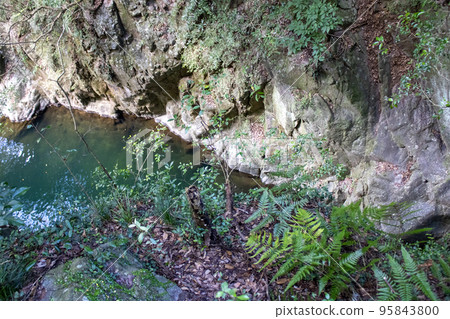 Clear stream flowing through rock surface Clear stream flowing through rock surface 95843800