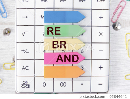 Rebrand text on colored stickers lying on the calculator Rebrand text on colored stickers lying on the calculator 95844641