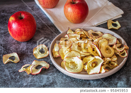 Dried organic apple slice chips in bowl Dried organic apple slice chips in bowl 95845953