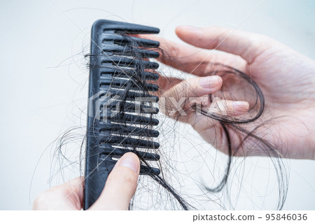 Asian woman have problem with long hair loss attach to comb brush. Asian woman have problem with long hair loss attach to comb brush. 95846036