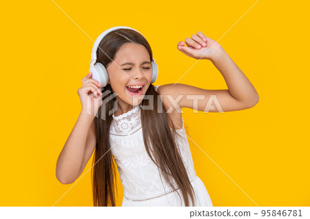 singing teen kid listen music in headphones on yellow background singing teen kid listen music in headphones on yellow background 95846781