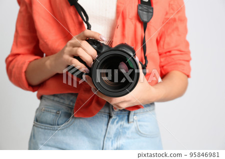Professional photographer working on white background in studio, closeup 95846981