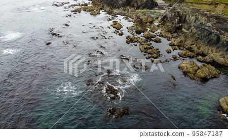 Coastal rocks under sea water, seascape. The coastline of the Atlantic Ocean, the north of Europe. Beautiful ocean water, top view. Aerial photo. View from above. Coastal rocks under sea water, seascape. The coastline of the Atlantic Ocean, the north of Europe. Beautiful ocean water, top view. Aerial photo. View from above. 95847187