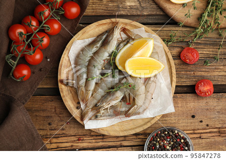 Flat lay composition with raw shrimps on wooden table 95847278