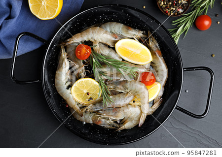 Flat lay composition with raw shrimps on black table Flat lay composition with raw shrimps on black table 95847281