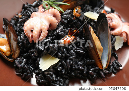 Delicious black risotto with seafood, closeup view Delicious black risotto with seafood, closeup view 95847308