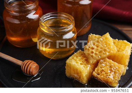 Composition with fresh honey on slate board Composition with fresh honey on slate board 95847651