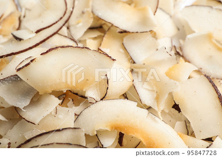 Delicious fresh coconut chips as background, closeup 95847728