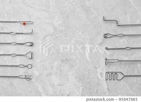 Set of different logopedic probes and space for text on marble table, flat lay. Speech therapist's tools 95847865
