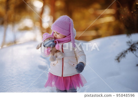 Charming little girl in a warm coat. 95848596