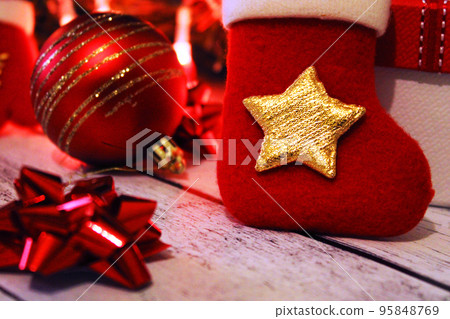 Christmas red and gold background with balls, bows, Christmas sock and gifts. 95848769