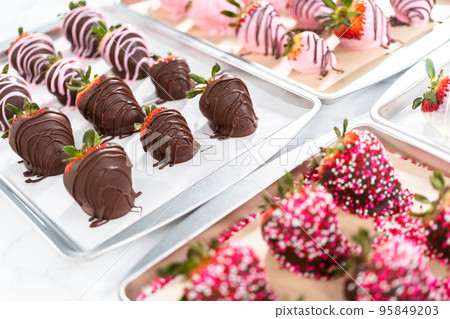 Variety of chocolate dipped strawberries on parchment paper. Variety of chocolate dipped strawberries on parchment paper. 95849203
