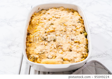 Cooking macaroni and cheese with broccoli in a casserole dish. Cooking macaroni and cheese with broccoli in a casserole dish. 95849224