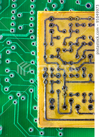 Printed green and yellow circuit boards. Electronic computer hardware technology macro. A digital motherboard chip. Microprocessor, transistors, semiconductor made from silicon. Technical science. Printed green and yellow circuit boards. Electronic computer hardware technology macro. A digital motherboard chip. Microprocessor, transistors, semiconductor made from silicon. Technical science. 95849973