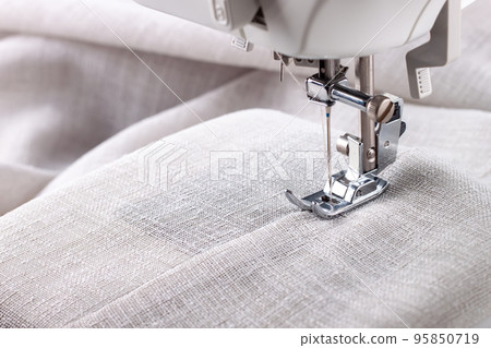 Modern sewing machine presser foot and item of clothes. Sewing process, handmade, hobby, business 95850719