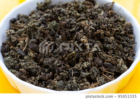 Dried Jiaogulan on yellow background. Dried Jiaogulan on yellow background. 95851335