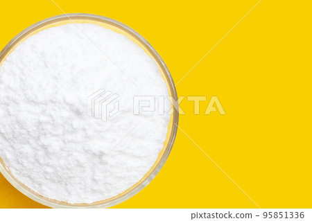 Baking soda on yellow background. Baking soda on yellow background. 95851336