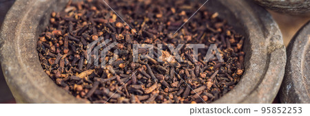 carnation grains, herbal medicinal herbs, dry carnation grains in a dish BANNER long format 95852253