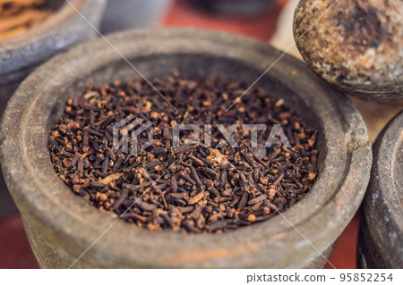 carnation grains, herbal medicinal herbs, dry carnation grains in a dish 95852254