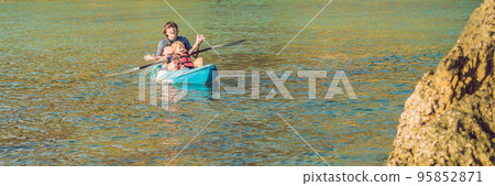 Father and son kayaking at tropical ocean. BANNER, long format Father and son kayaking at tropical ocean. BANNER, long format 95852871
