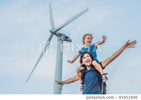 Father carrying son on shoulders and waving their arms like a windmill 95852886