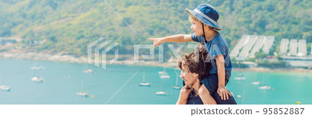 Father and son in the background of Promthep cape and Yanui beach. Phuket, Thailand. Traveling with children concept BANNER, long format 95852887