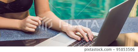 BANNER Young female freelancer sitting near the pool with her laptop in the hotel browsing in her smartphone. Busy at holidays. Distant work concept. Copy space for your text long format 95853506