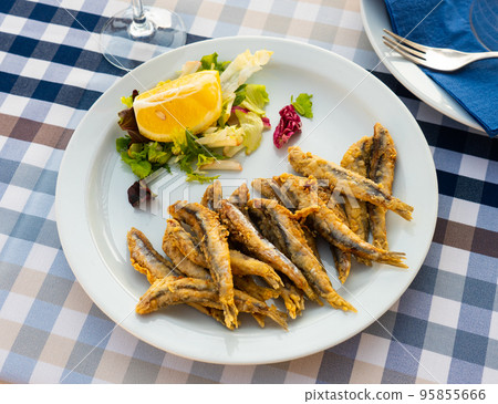 Fried in batter anchovies with fresh vegetables and lemon Fried in batter anchovies with fresh vegetables and lemon 95855666