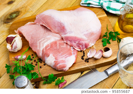 Raw pork secreto steak and spices prepared for cooking on wooden board 95855687
